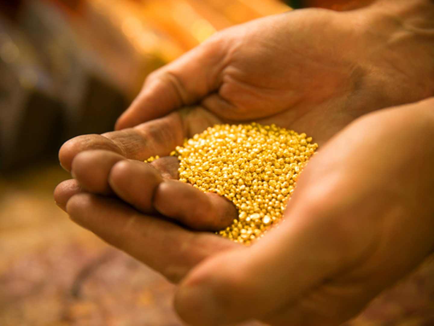 The Perth Mint Refinery- hands holding gold granules