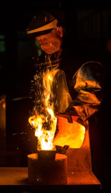 a Perth Mint gold pourer pouring gold